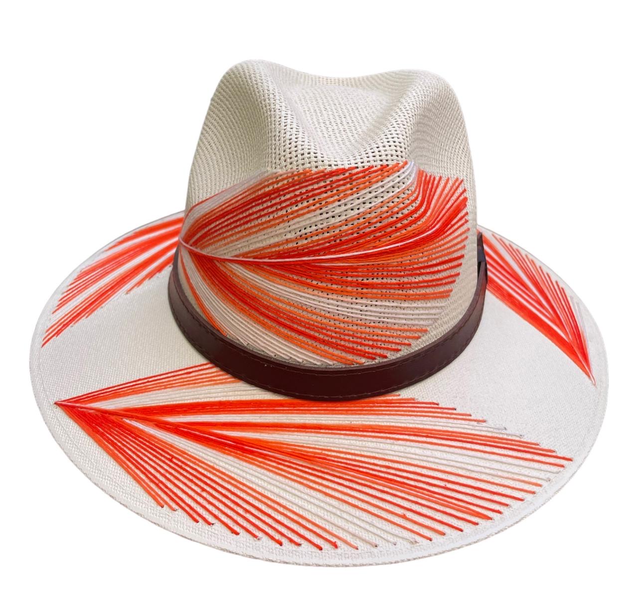 white hat with red palm frond designs and a brown leather band.