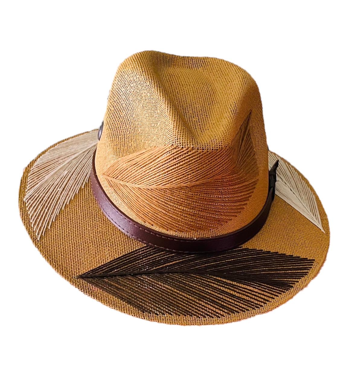 tan hat with brown and beige palm frond designs and a brown leather band.