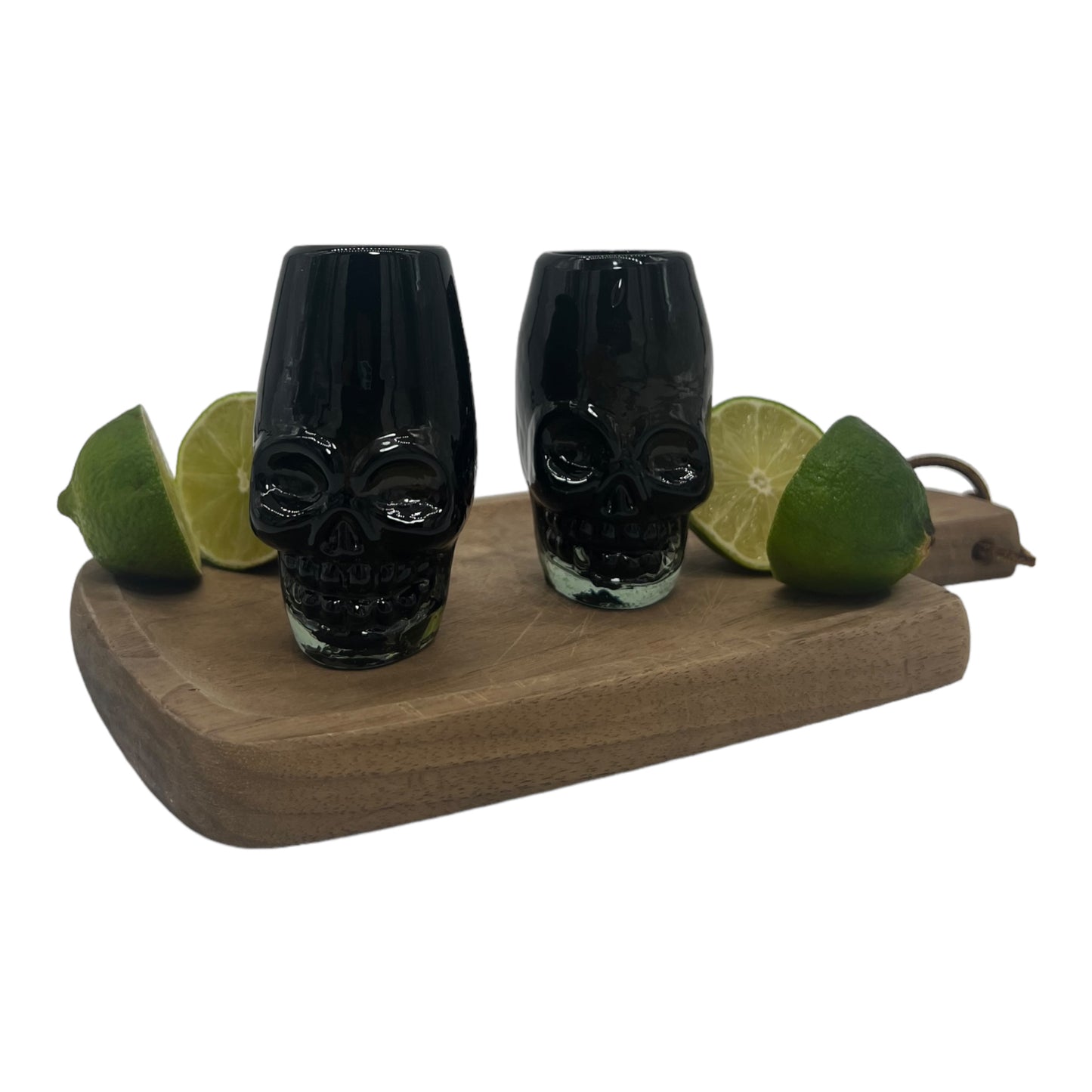 Black traditional Mexican shot glass shaped like a skull, made from handblown, eco-friendly recycled glass. It is sturdy, dishwasher safe, and holds approximately 2 fluid ounces.