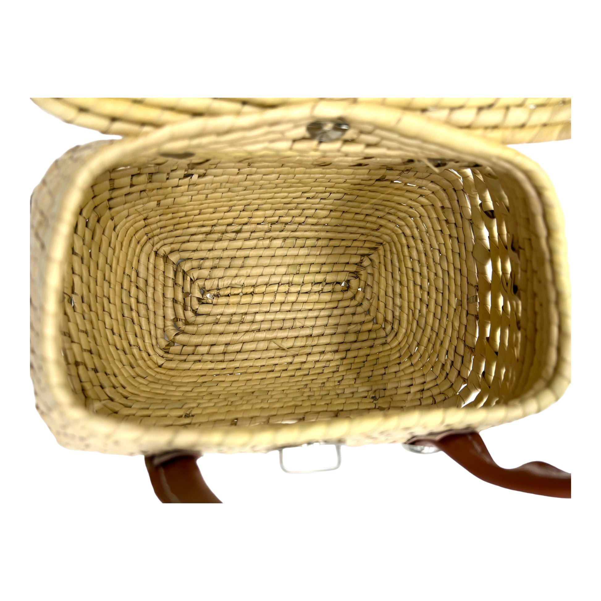 open woven palm handbag showing its spacious, rectangular interior.