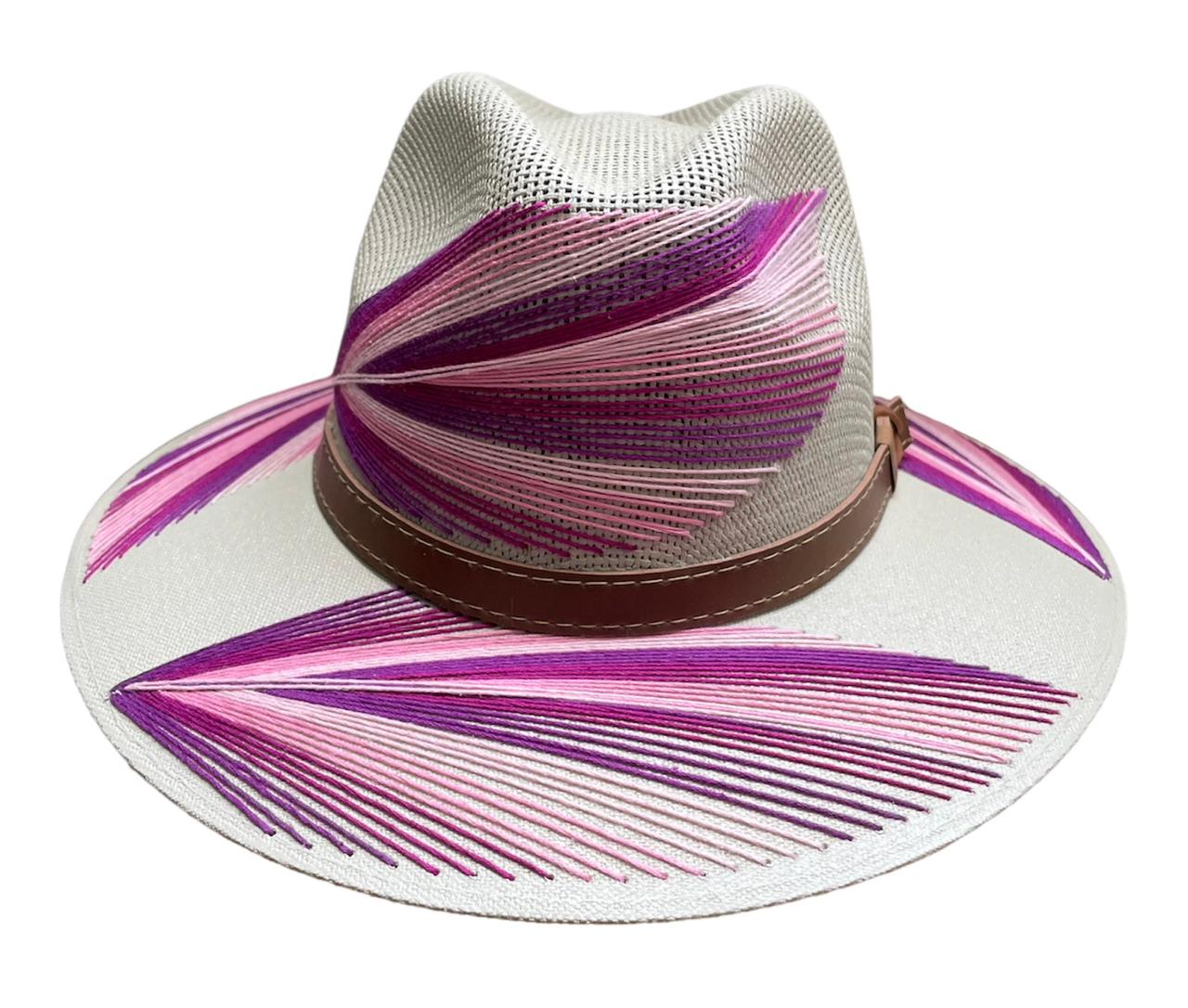 white hat with pink and purple palm frond designs, featuring a brown leather band.