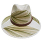 beige hat with green palm frond designs and a brown leather band.