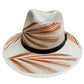 white hat with brown palm frond designs and a black leather band.