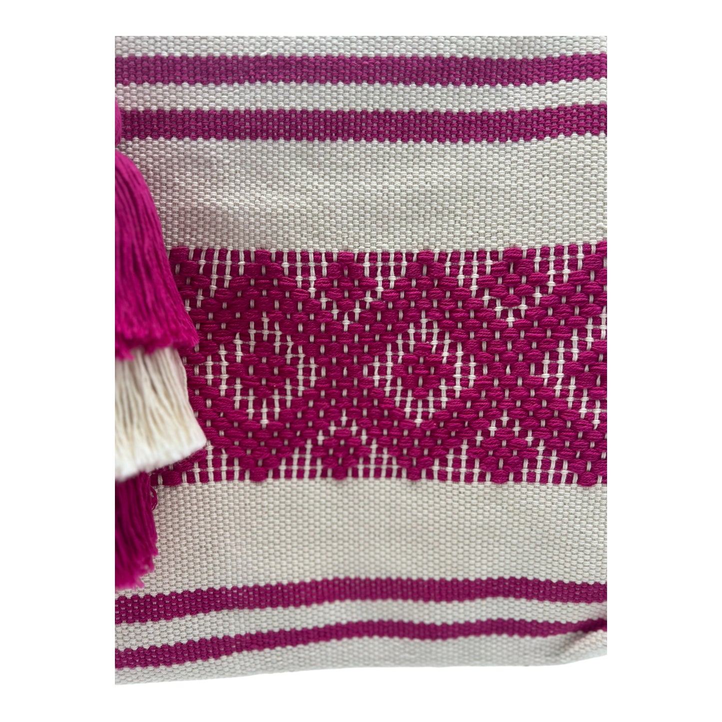 beige tote bag featuring horizontal pink stripes and patterns, accented with a multi-layered  tassel.