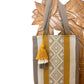 woven tote bag with vertical stripes in mustard yellow, beige, and brown, featuring a decorative tassel.