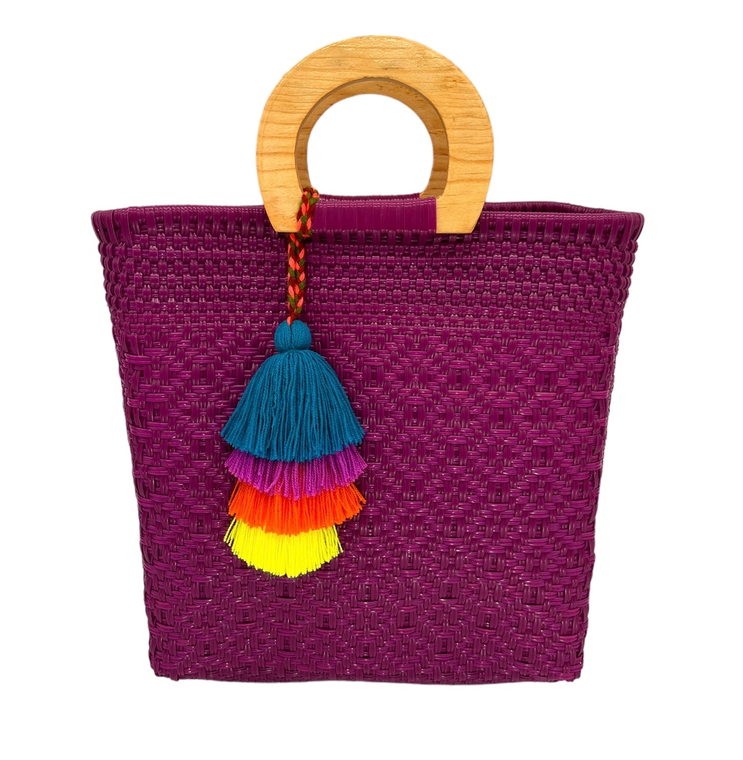 purple woven tote bag made of recycled plastic with a wooden circular handle. The bag is adorned with a tassel charm