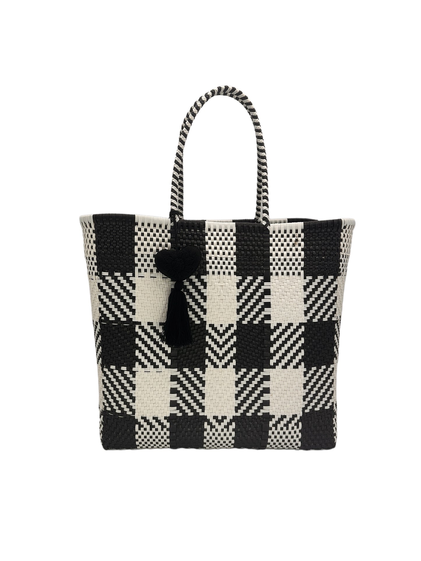 black and white checkered tote bag with two handles and a small black heart and tassel attached.