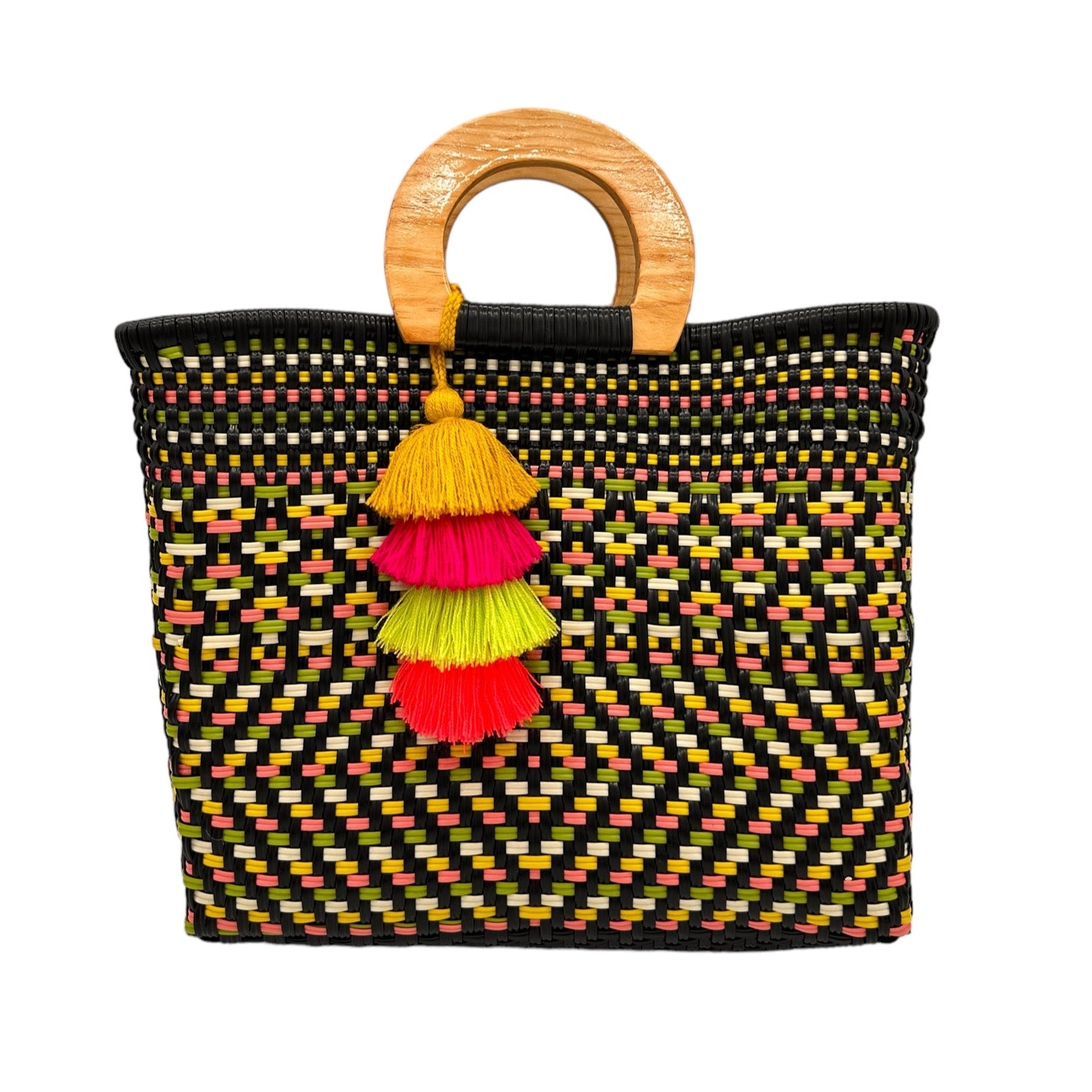 woven tote bag made of recycled plastic with a wooden circular handle. The bag features stripes and geometric patterns in bright colors, including black, green, yellow, pink. It is adorned with a coordinating pompon