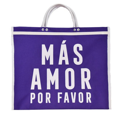 purple tote bag with white handles and "MÁS AMOR POR FAVOR" in large white letters.