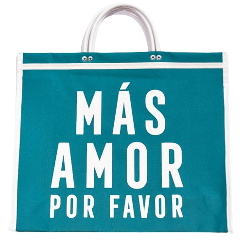 teal tote bag with white handles and the words "MÁS AMOR POR FAVOR" printed in large white letters.