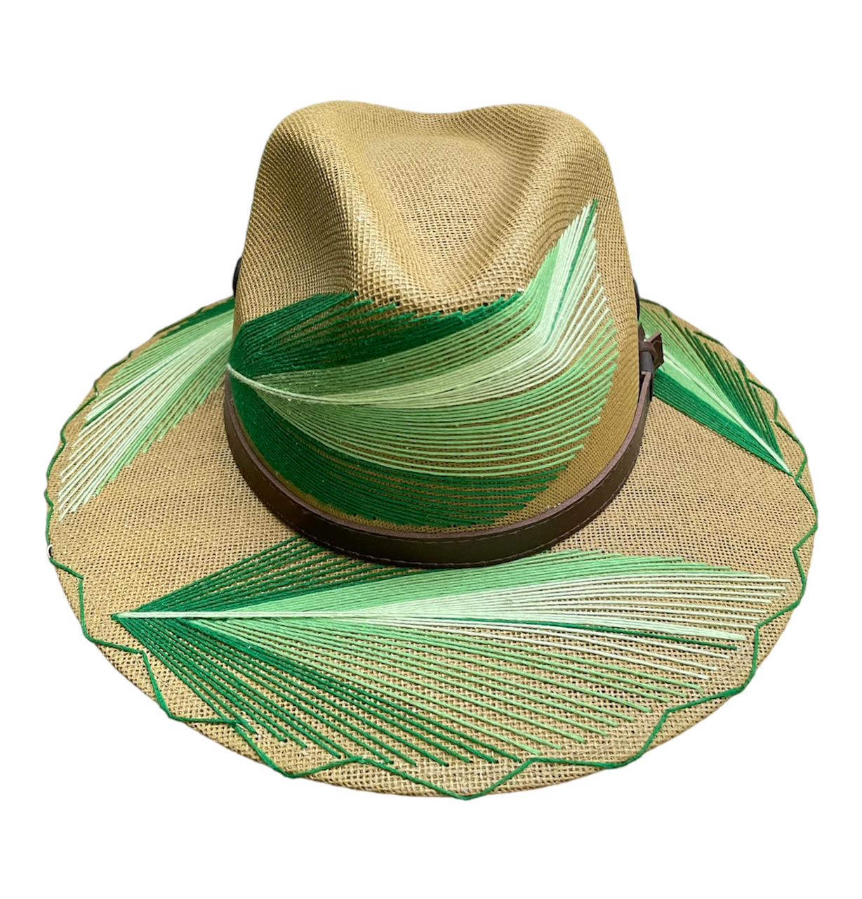 tan hat with a wide brim featuring green and light green painted designs resembling palm fronds. It has a brown leather band around the base of the crown.