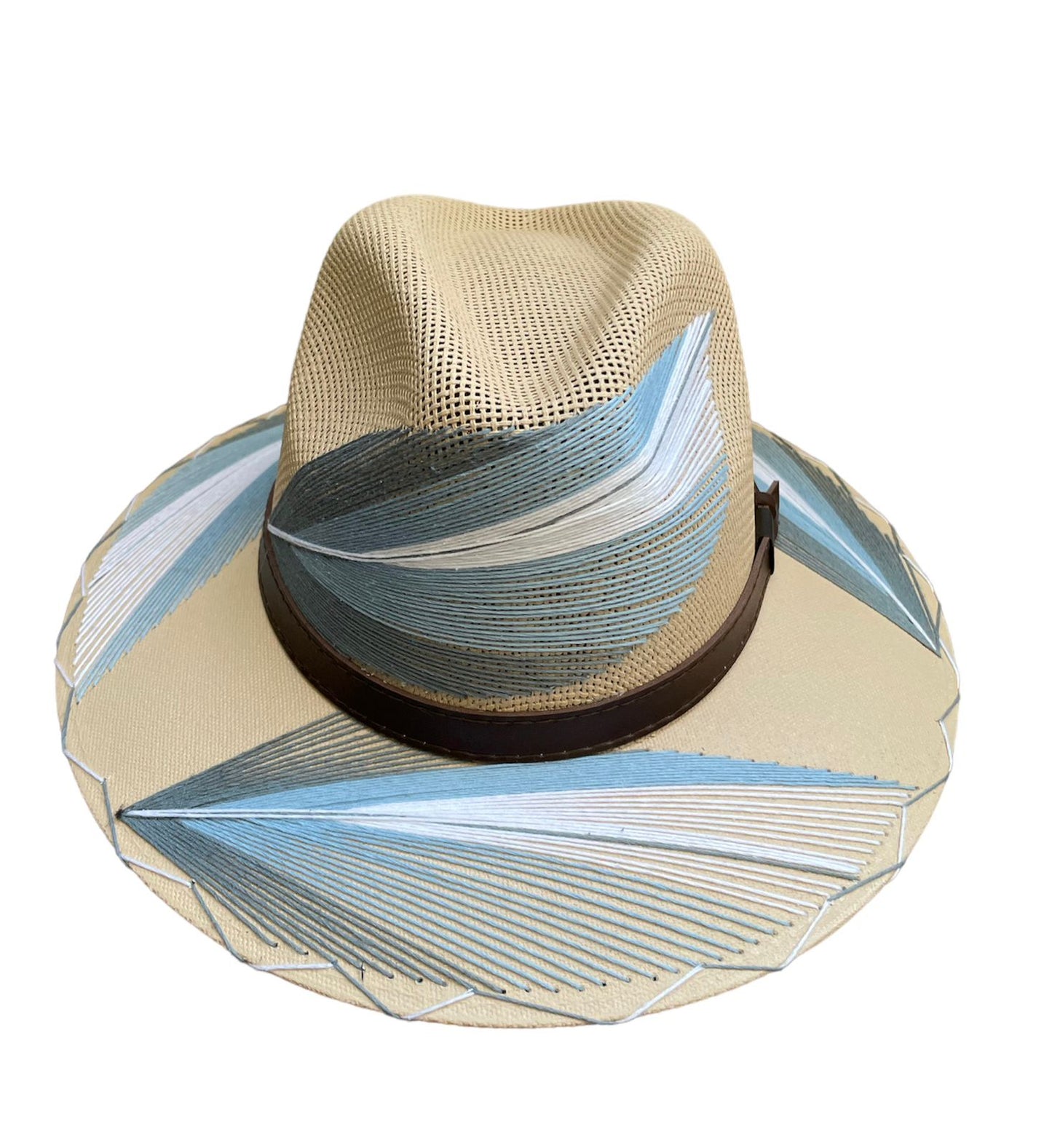 beige hat with light blue and white palm frond designs and a brown leather band.