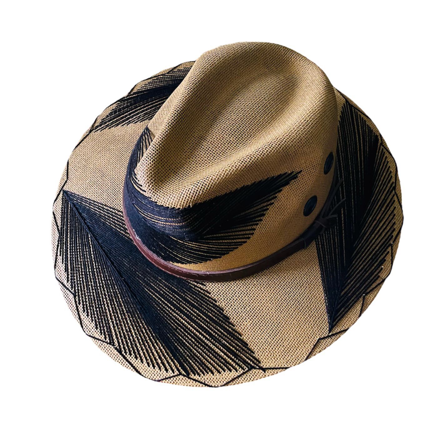 tan hat with black palm frond designs and a brown leather band.