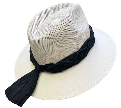 white hat with a wide brim and a black braided rope band, topped with a black tassel.