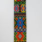 Close-up of a colorful beaded strap with intricate geometric and floral patterns in vibrant hues, showcasing detailed craftsmanship.