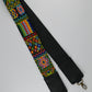 Colorful beaded strap with intricate geometric patterns and black leather ends, featuring metal clasps for attachment.