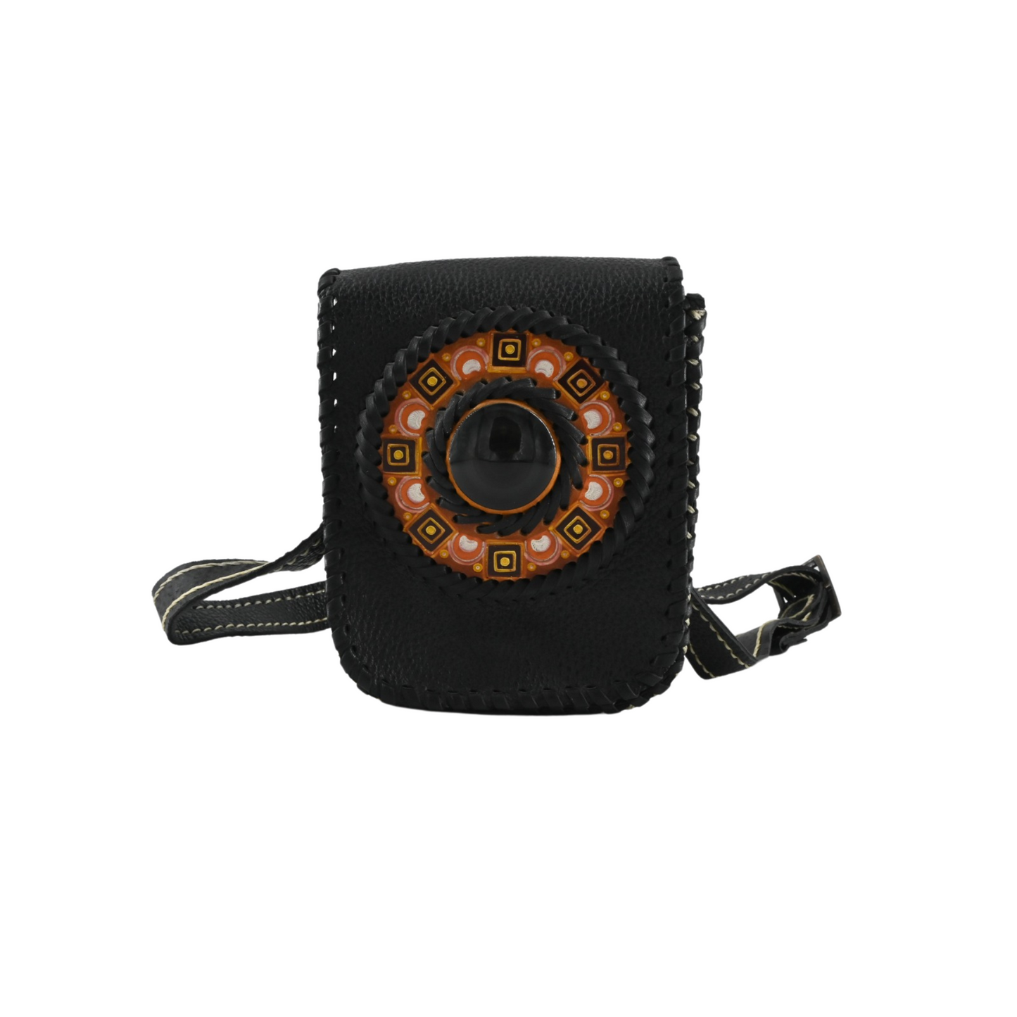 small black crossbody bag with a circular medallion on the front, featuring orange, black, and yellow geometric patterns. It has an adjustable shoulder strap with white stitching along the edges.