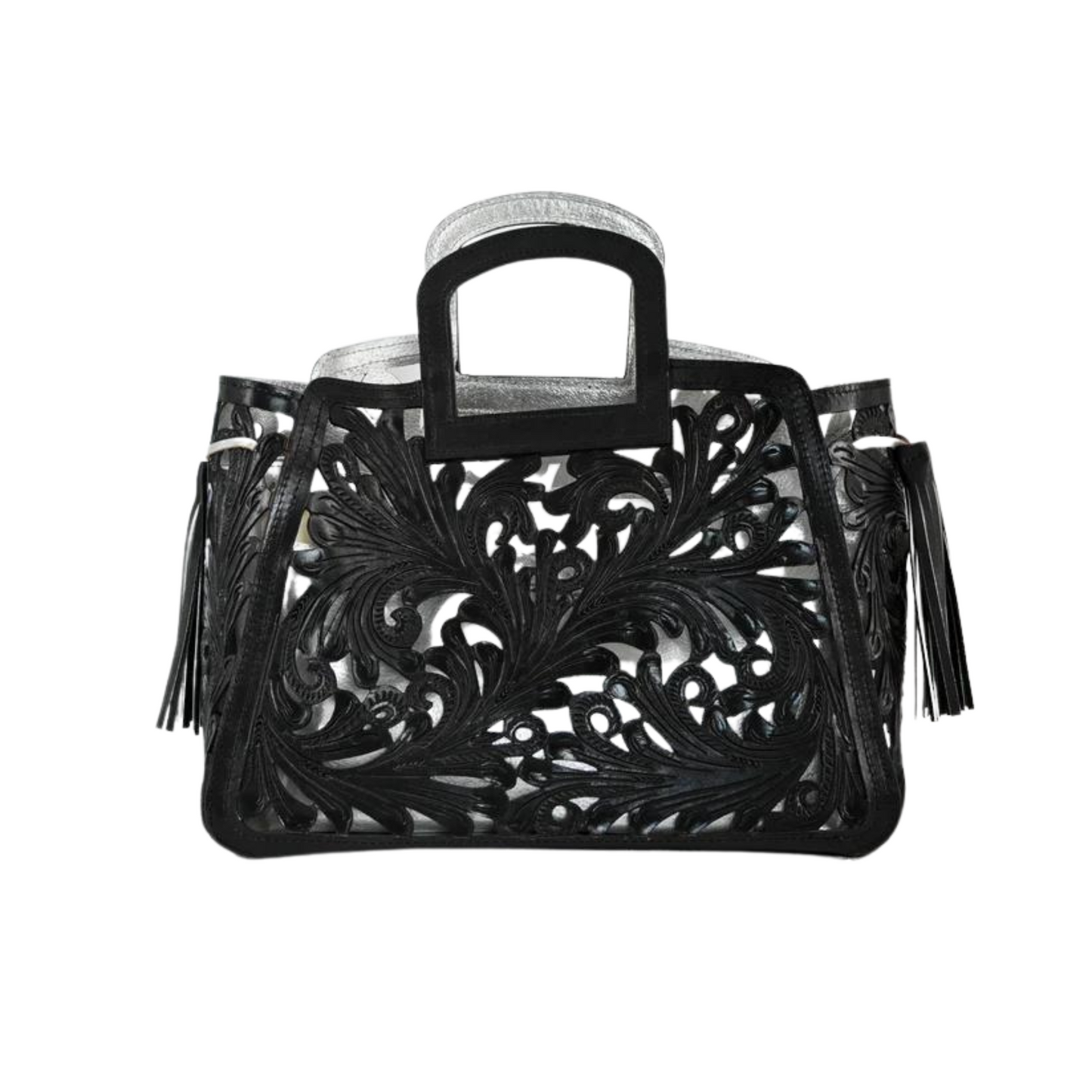 handbag with intricate, swirling cut-out designs in black leather overlaying a metallic silver background. The bag features a rectangular handle and leather tassels on the sides.