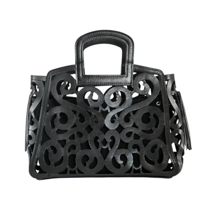 black leather tote with an intricate scroll pattern, featuring a rectangular handle and leather tassels on both sides.