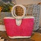 shows a woven handbag with a red body and a circular handle