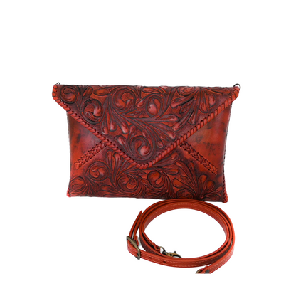 burgundy crossbody bag with intricate embossed floral patterns, designed to hold an iPad and other essentials.