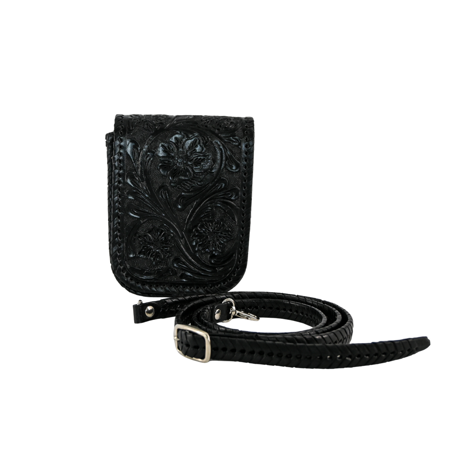 black leather crossbody sling bag with floral carvings and a braided, adjustable strap. It features a magnetic snap closure and a back pocket for easy access.