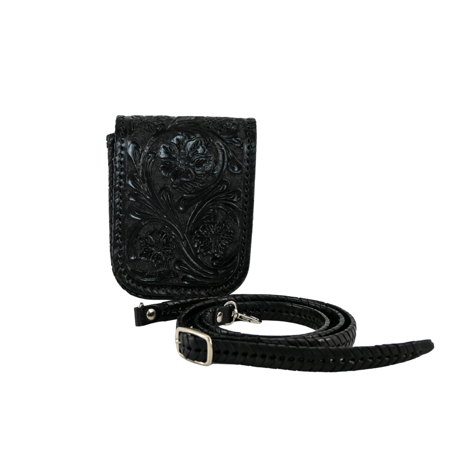 black leather crossbody sling bag with floral carvings and a braided, adjustable strap. It features a magnetic snap closure and a back pocket for easy access.