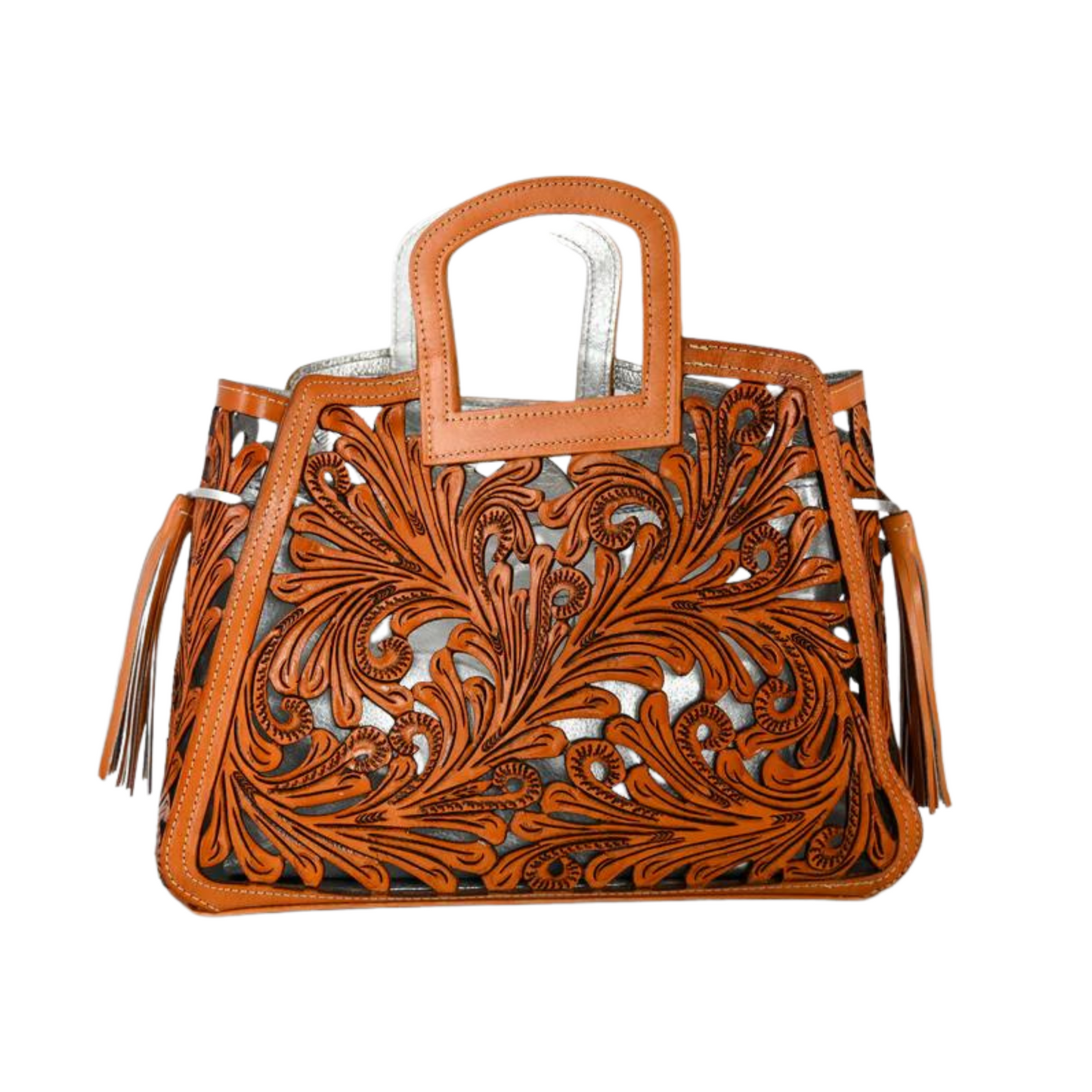 handbag with intricate, swirling cut-out designs in a honey-colored leather overlaying a metallic silver background. The bag has a rectangular handle and leather tassels on the sides.