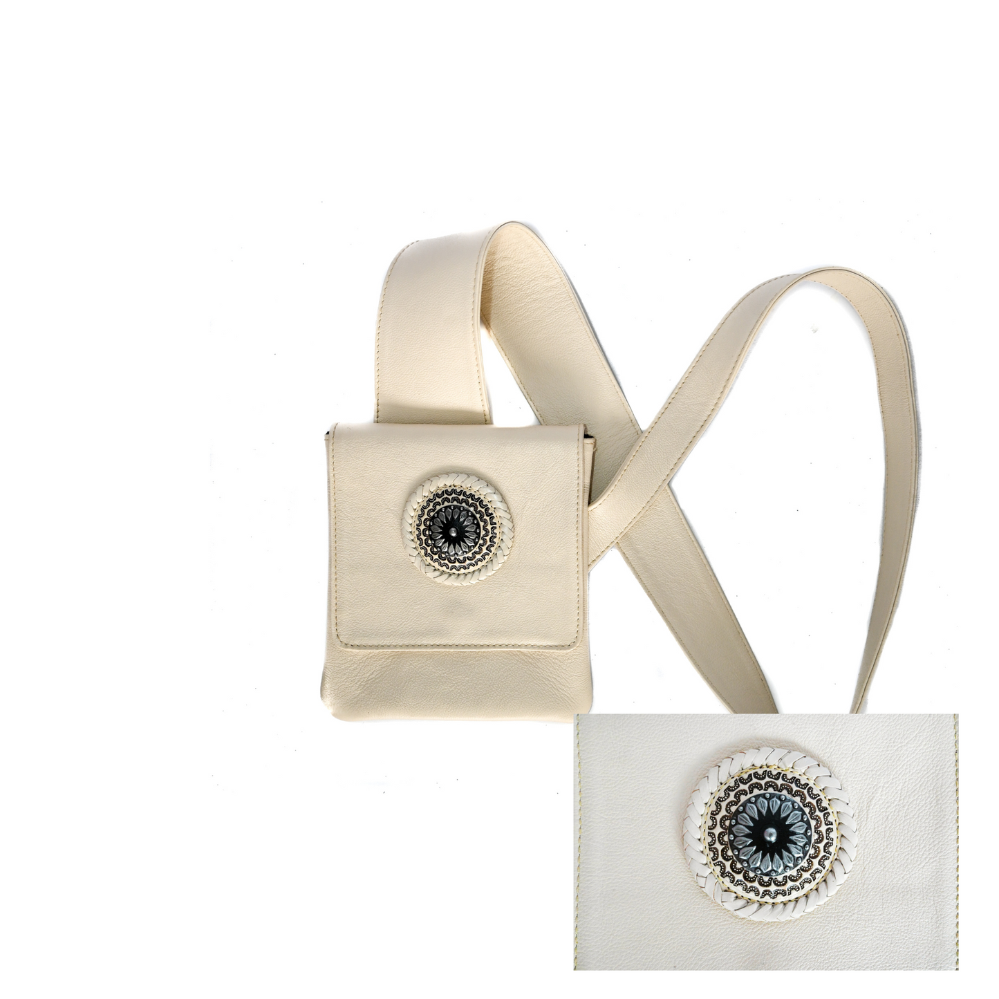 light cream leather crossbody bag with an ergonomic strap and a decorative circular medallion on the front flap.