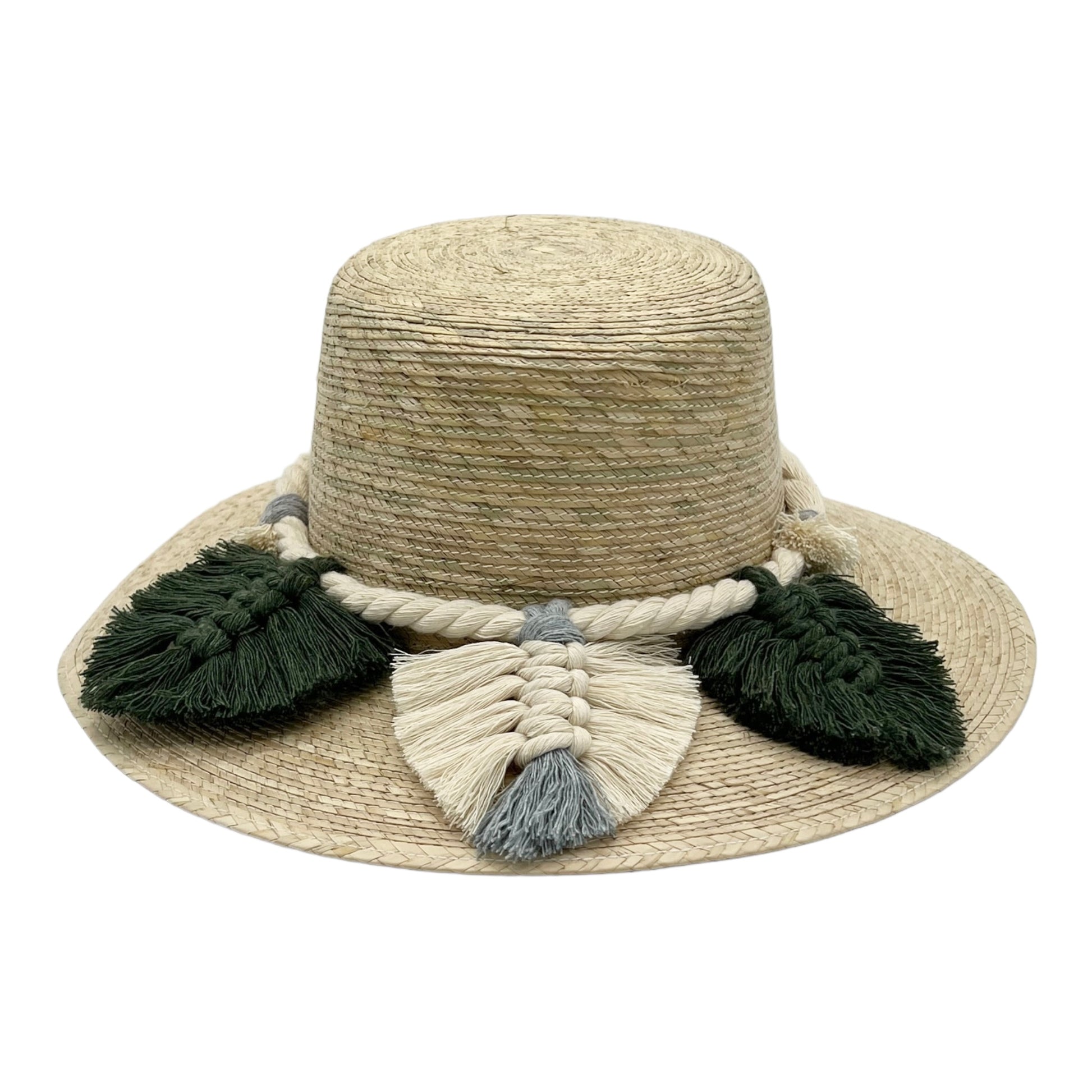 natural straw hat with a wide brim, featuring a thick braided band with large cream and dark green tassels around the crown.