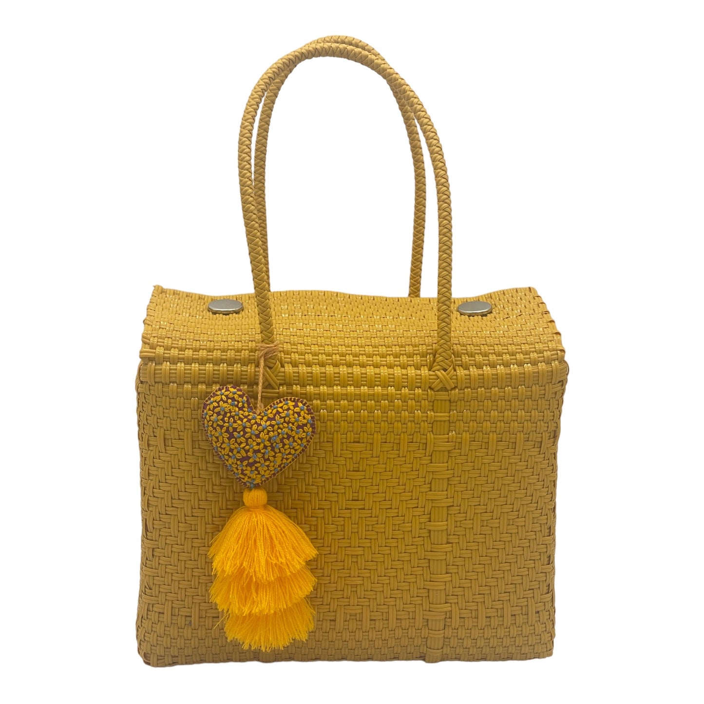 mustard yellow woven handbag with double handles, featuring a heart-shaped tassel charm adorned 