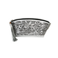 platinum-colored leather cosmetic bag with hand-tooled floral patterns on both sides. It features braided seams, a full zipper top, a sueded interior, a decorative tassel, and brass studs at the bottom.