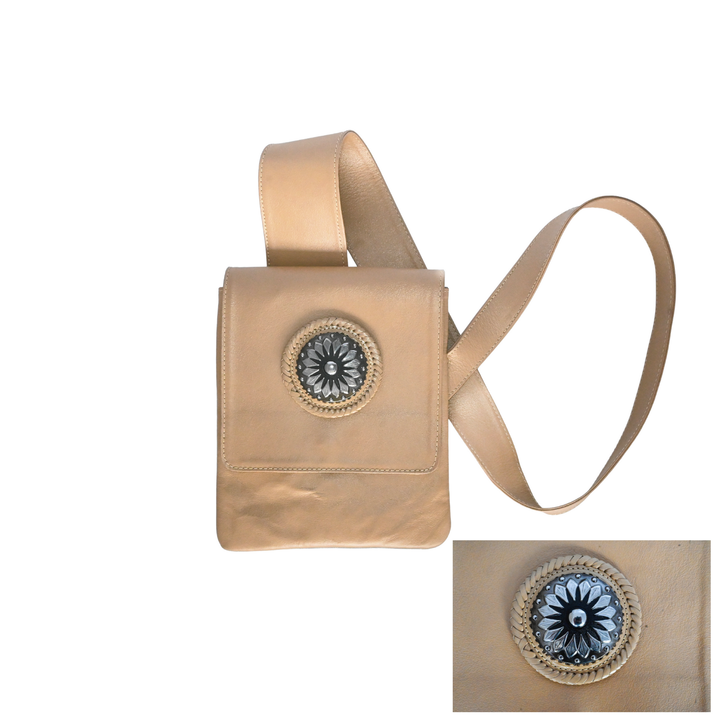 tan leather crossbody bag with an ergonomic strap and a decorative circular medallion on the front flap.