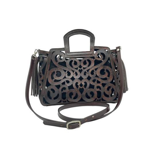 Musical Notes Crossbody - brown handbag with an intricate cut-out pattern, a sturdy top handle, an adjustable shoulder strap, and a tassel accent on the side.