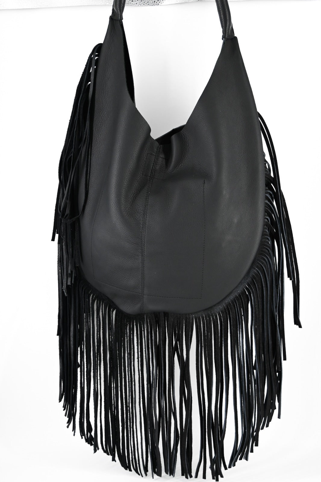 black leather bag with long fringe details along the sides and bottom.