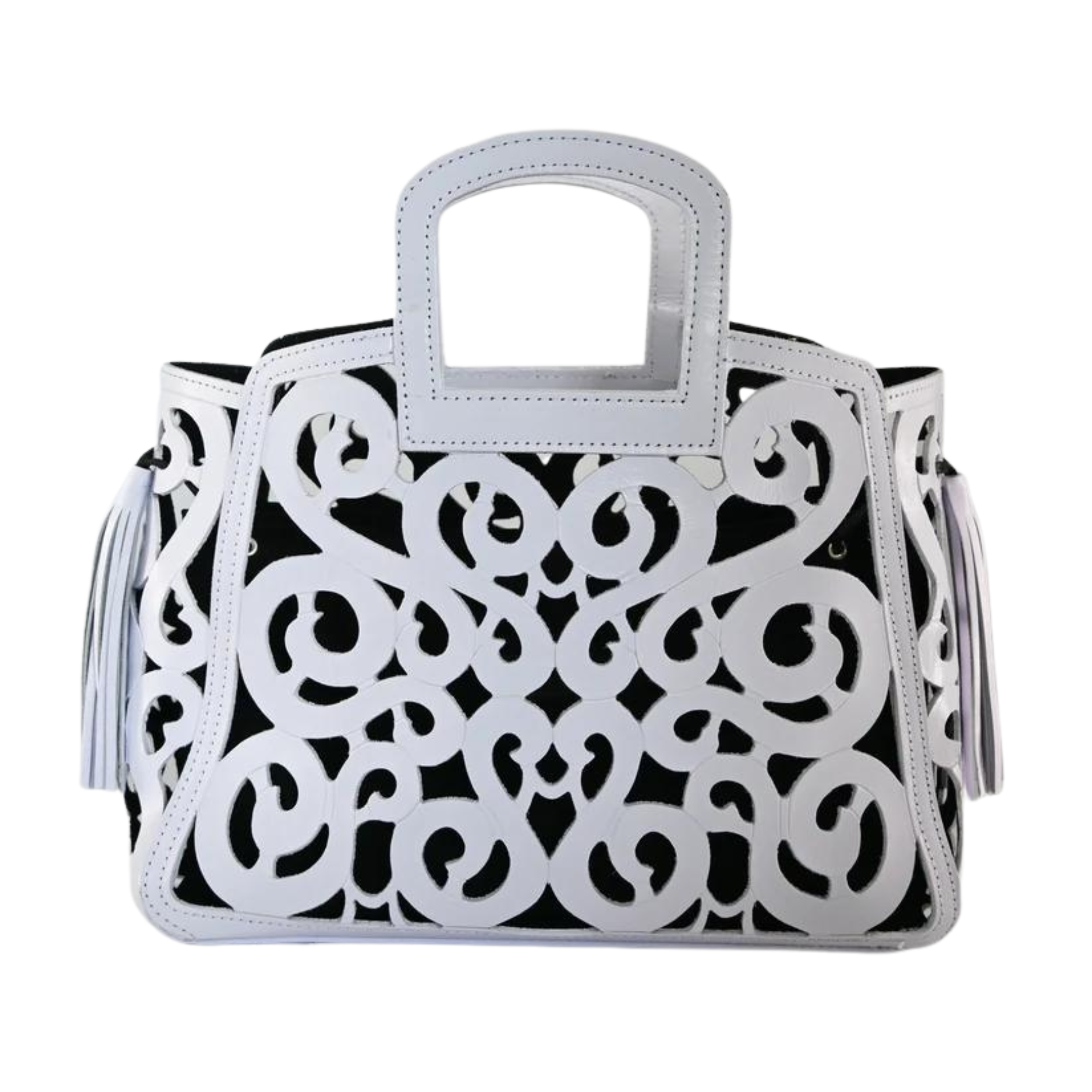 white leather tote with intricate scroll patterns and side tassels. It has a cut-out handle and a detailed decorative design.