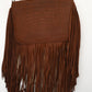 tan leather crossbody bag with a crocodile pattern on the flap and long fringe hanging from the bottom.