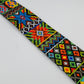 Close-up of a colorful beaded strap with intricate geometric and floral patterns in vibrant hues, showcasing detailed craftsmanship.