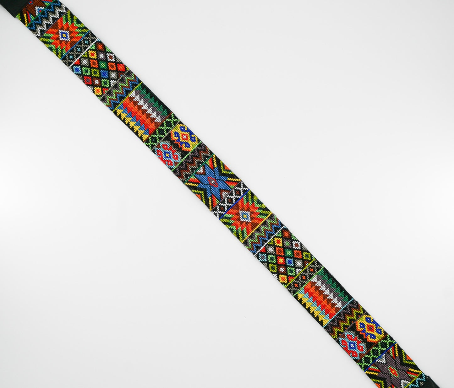Close-up view of a colorful beaded strap with intricate traditional patterns, showcasing vibrant geometric designs and detailed craftsmanship.