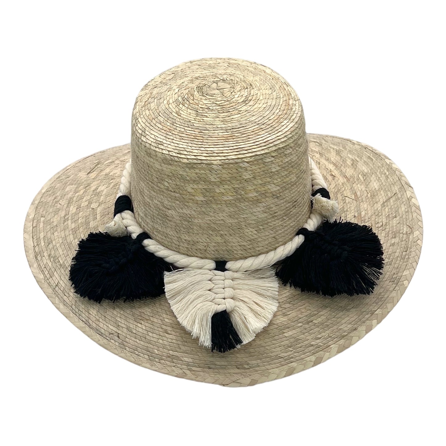 natural straw hat with a wide brim, featuring a decorative braided band adorned with black and white tassels.