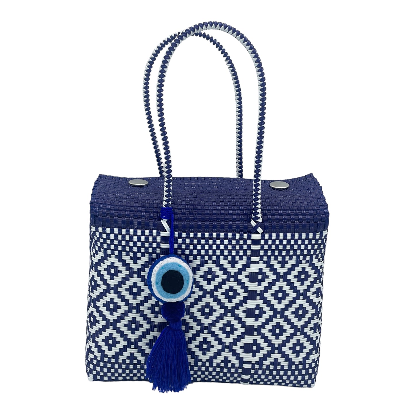 blue and white woven handbag with geometric patterns, featuring a decorative tassel with a circular charm.