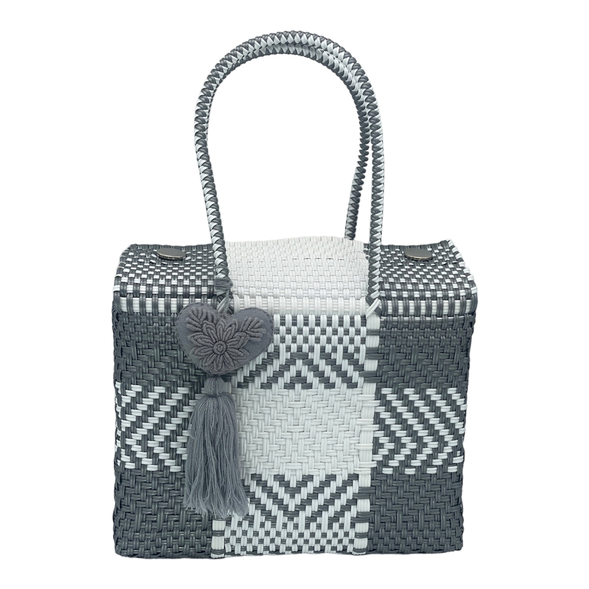 gray and white woven handbag with geometric patterns, featuring a decorative heart-shaped tassel.