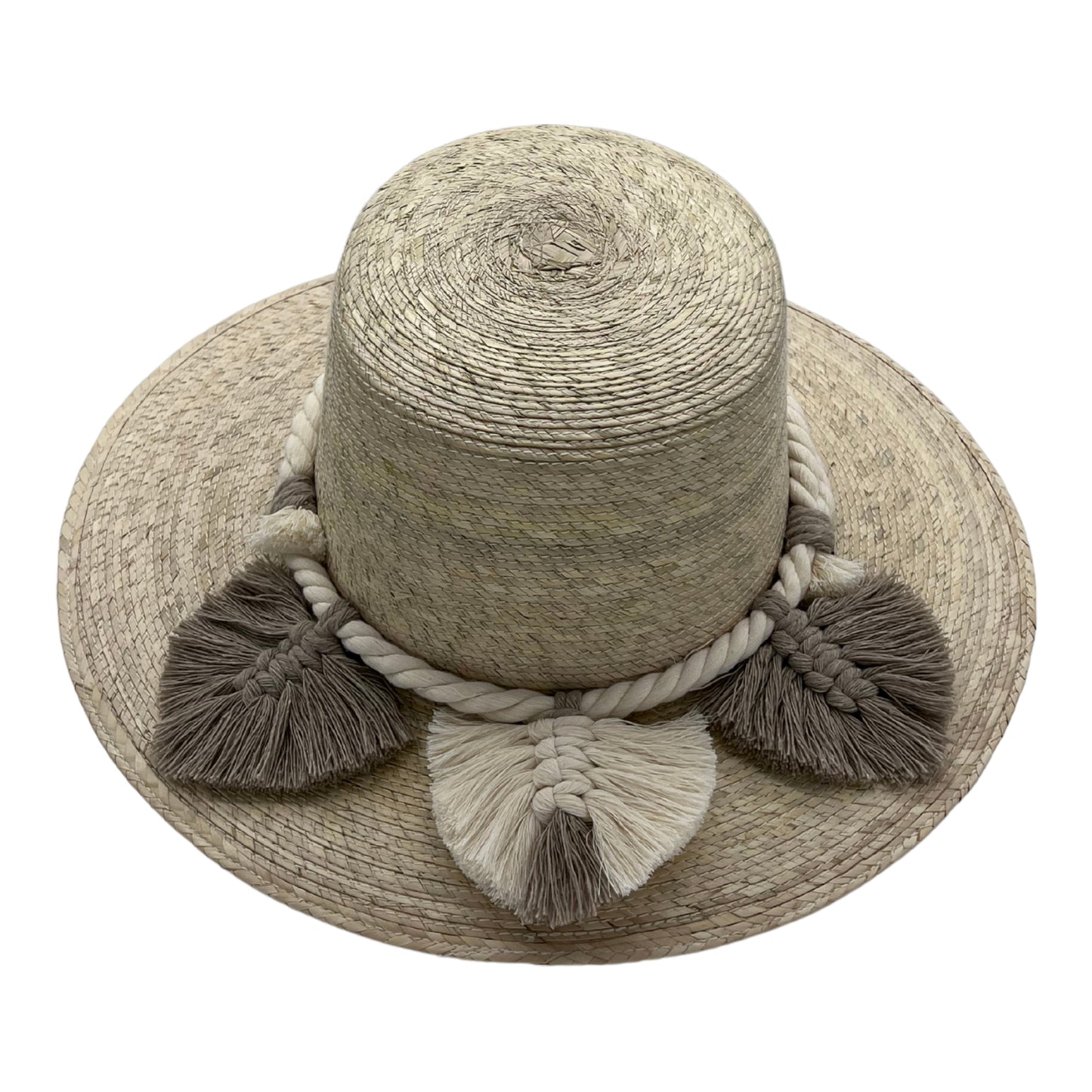 natural straw hat with a wide brim, featuring a thick braided band with large cream and brown tassels around the crown.