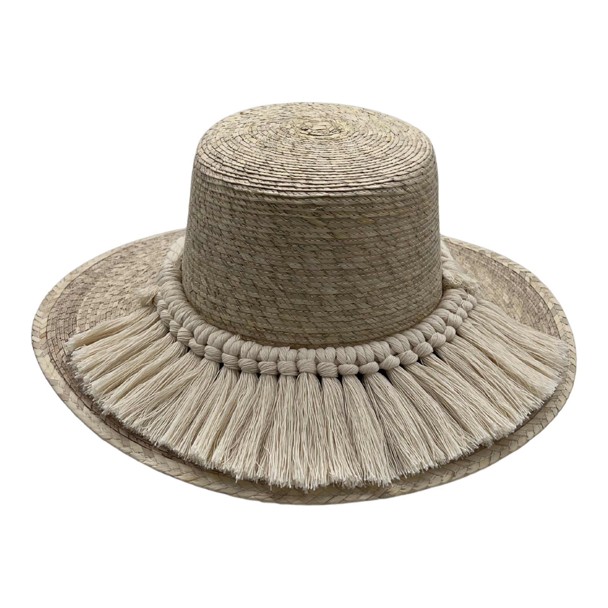 wide-brimmed hat made of Mexican palm leaf straw, featuring a decorative band and fringed ivory trim around the base.