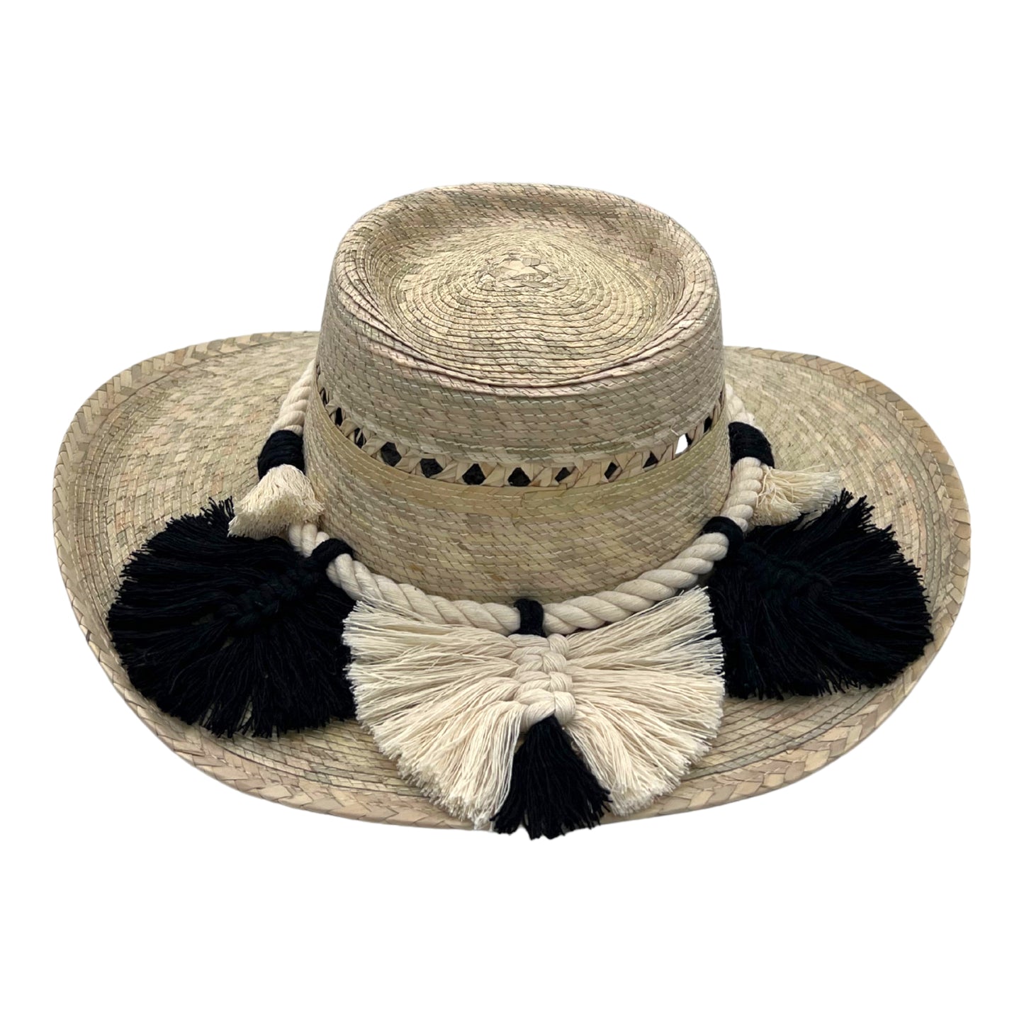 natural straw hat with a flat crown, decorated with black and cream braided cotton rope and tassels around the base.