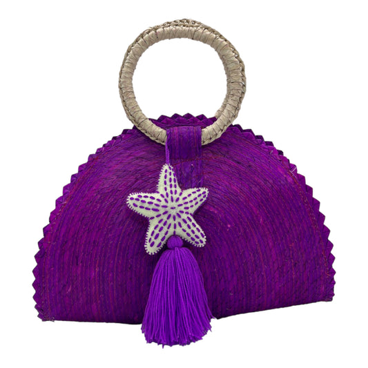 vibrant purple woven palm handbag with a circular handle wrapped in beige material. The bag is adorned with a starfish decoration and a tassel.