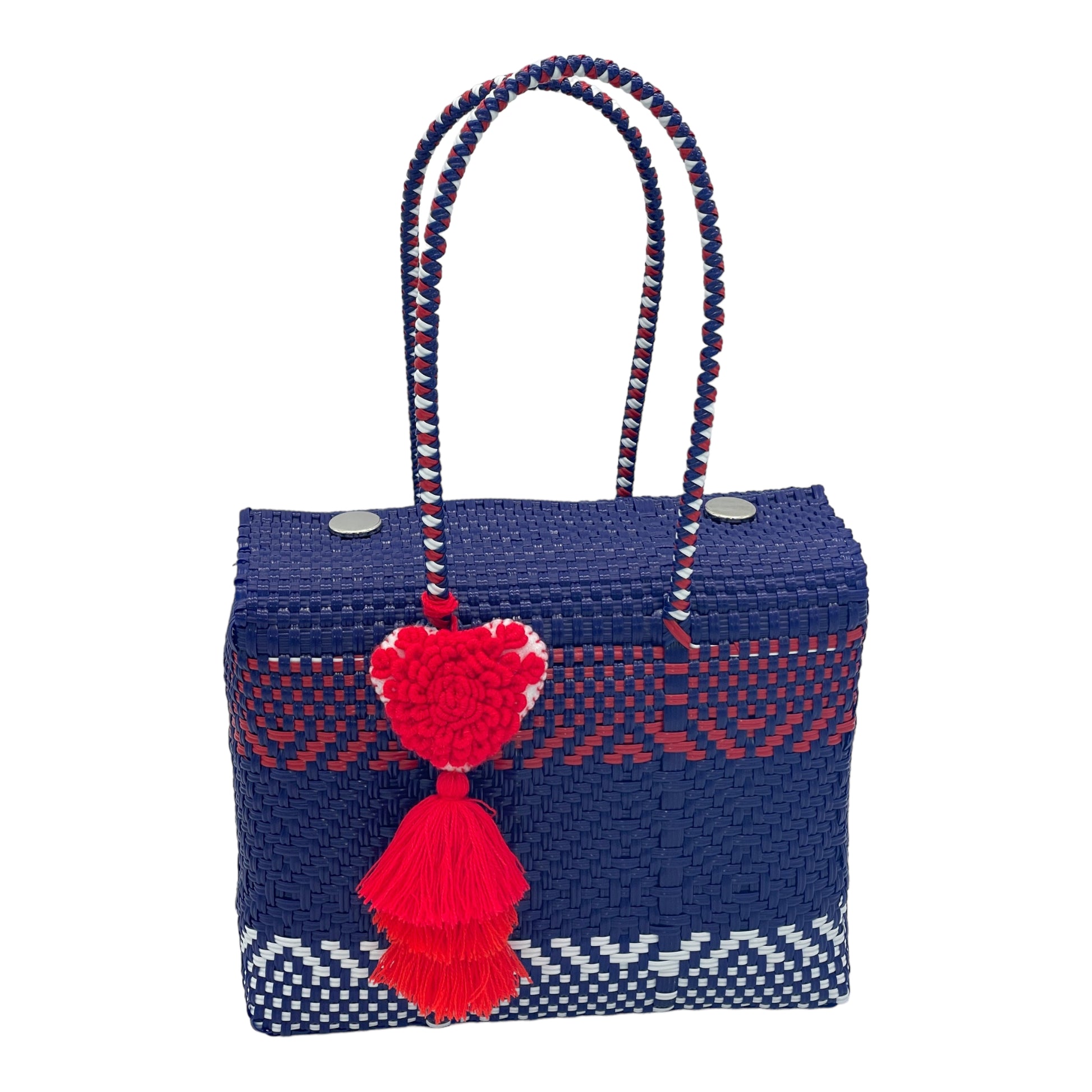 blue and red woven handbag with geometric patterns, featuring a decorative tassel with a heart.