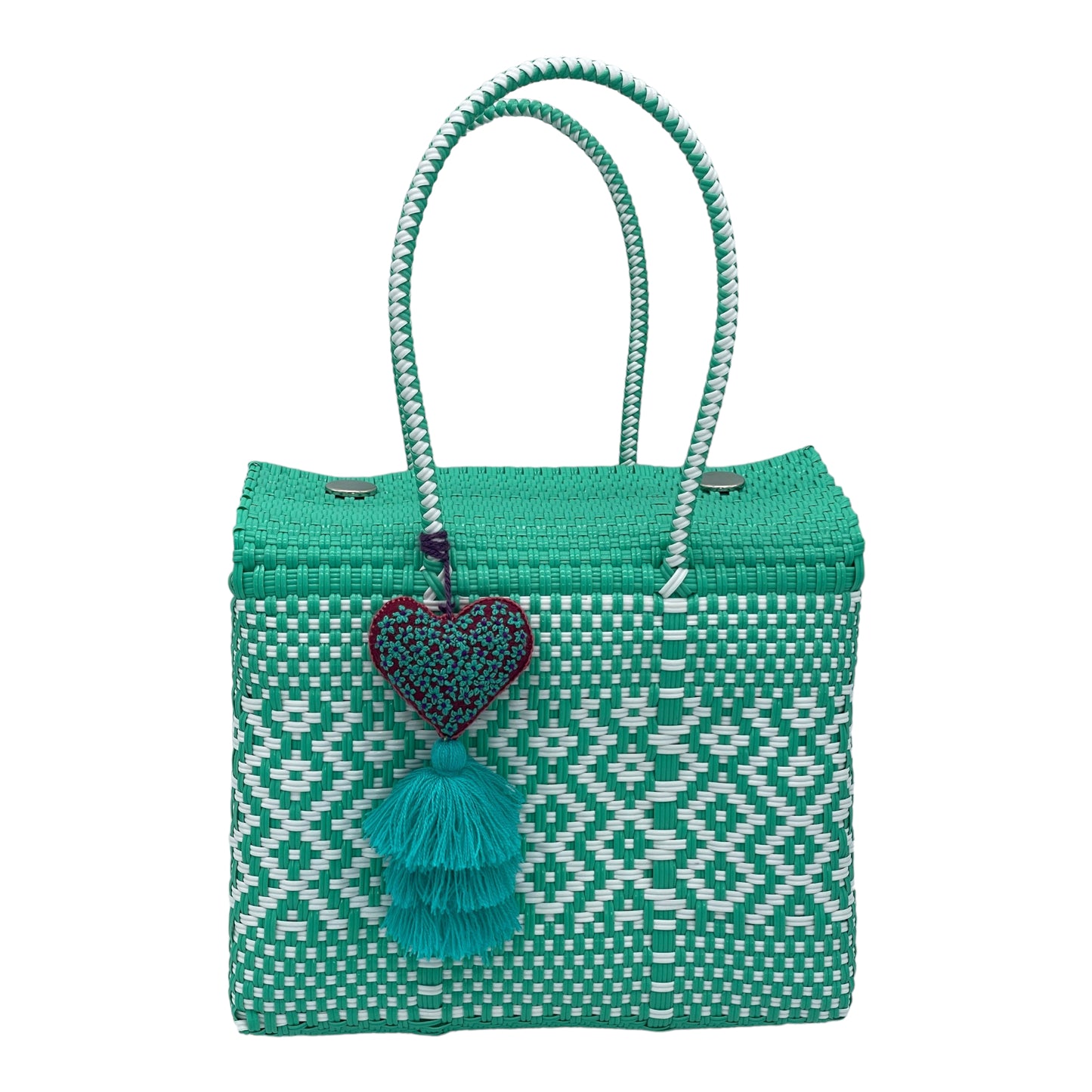 turquoise and white woven handbag with geometric patterns, featuring a decorative  tassel with a heart.