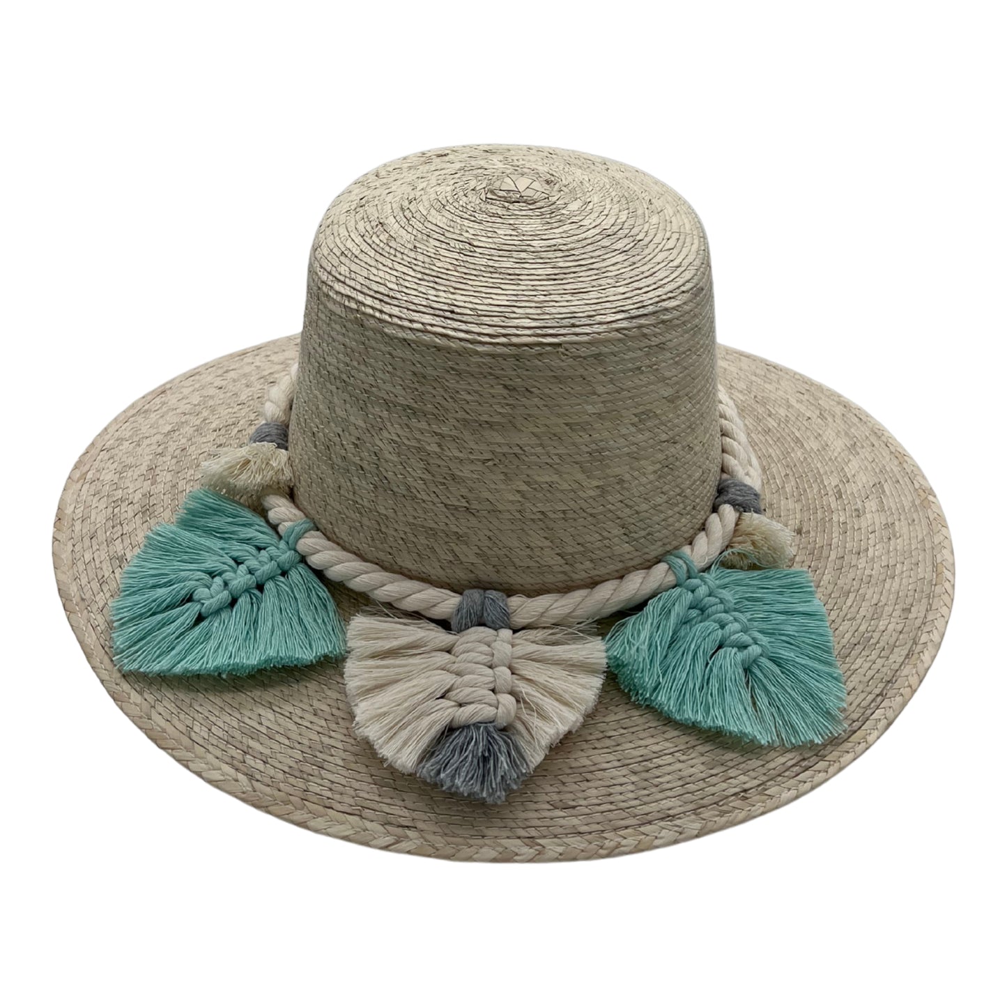 natural straw hat with a wide brim, featuring a thick braided band with large cream and mint green tassels around the crown.